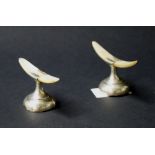 Two hallmarked silver and mother of pearl knife rests (A/F)