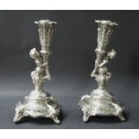 Continental white metal pair of ornate candlesticks.