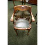 An oak gentleman's desk chair with spindle back and green leather pad seat