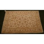 An Iranian floor rug with floral and geometric designs on a predominantly cream ground,