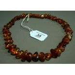 A Baltic amber strand necklace of graduated beads with a screw clasp