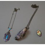 A silver-mounted large gemstone pendant on a silver chain and various enamelled jewellery
