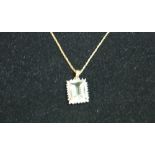A 9ct gold aquamarine and diamond pendant complete with a 9ct gold chain