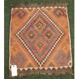 An Asian Kelim rug with geometric designs and fringed to the shorter edges.