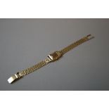 18ct. gold cased ladies dress watch on a 9ct. gold strap.  Total weight approximately 24.