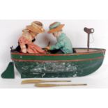 An early 20th century clockwork rowing boat toy, comprising metal hulled (zinc?) painted boat with