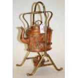 An Arts & Crafts copper spirit kettle on