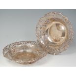 A pair of early 20th century Irish silver fruit bowls, each having fruiting vine cast rims and