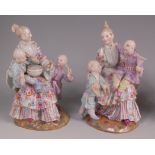 A pair of Meissen porcelain malabar figure groups, each modelled as a seated mother with two