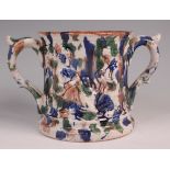 A 19th century Staffordshire loving cup, relief moulded and presented to John Piggin, the interior