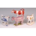 A collection of four Staffordshire cow c