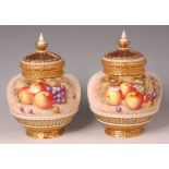 A pair of Royal Worcester porcelain fruit painted pot pourri vases and covers, by John Freeman &