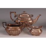 An Edwardian silver three piece teaset, comprising teapot, twin handled sugar and cream, each of