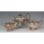 A George IV silver three piece tea service, comprising; pedestal teapot, twin handled sugar and