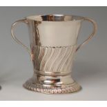 A circa 1900 silver loving cup, of tapering spiral fluted circular form, gilt washed interior, 5.