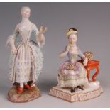 A Meissen porcelain figure of a standing woman in 18th century dress, heightened in gilt, blue
