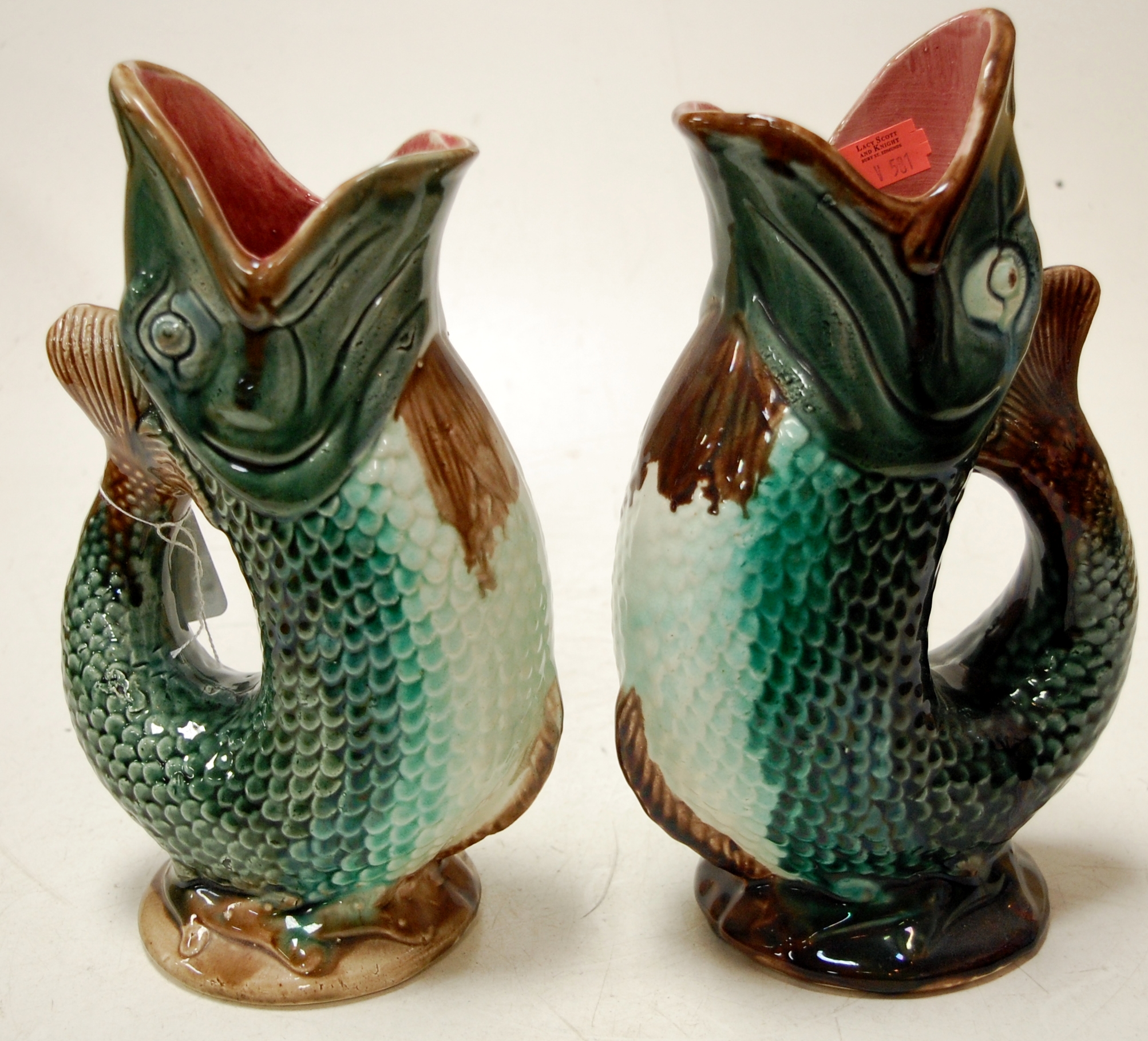 A pair of Victorian pottery fish vases Condition Report / Extra Information One vase with firing