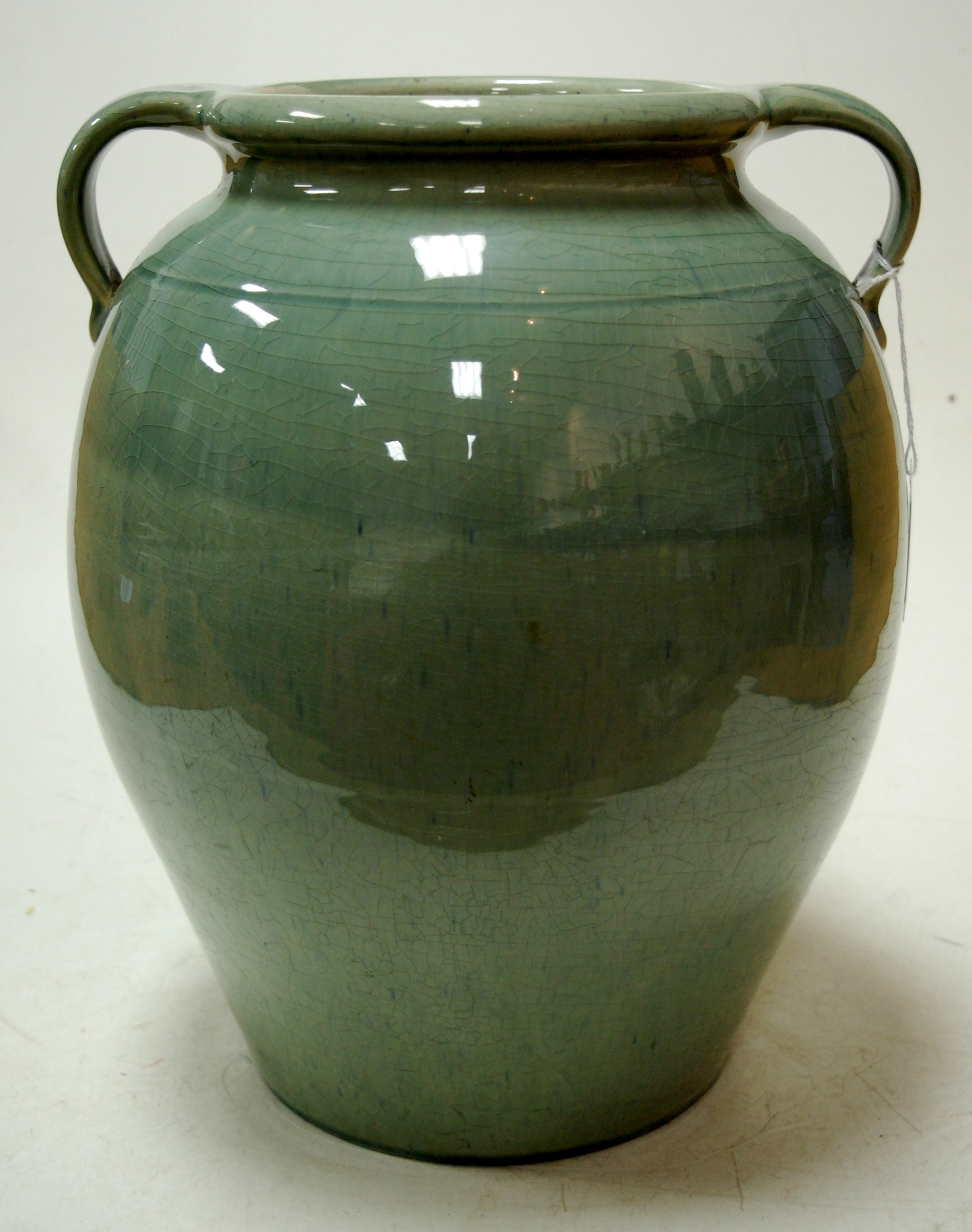 A large early 20th century C.H. Brannam of Barnstable celadon glazed twin-handled pottery vase,