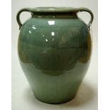 A large early 20th century C.H. Brannam of Barnstable celadon glazed twin-handled pottery vase,