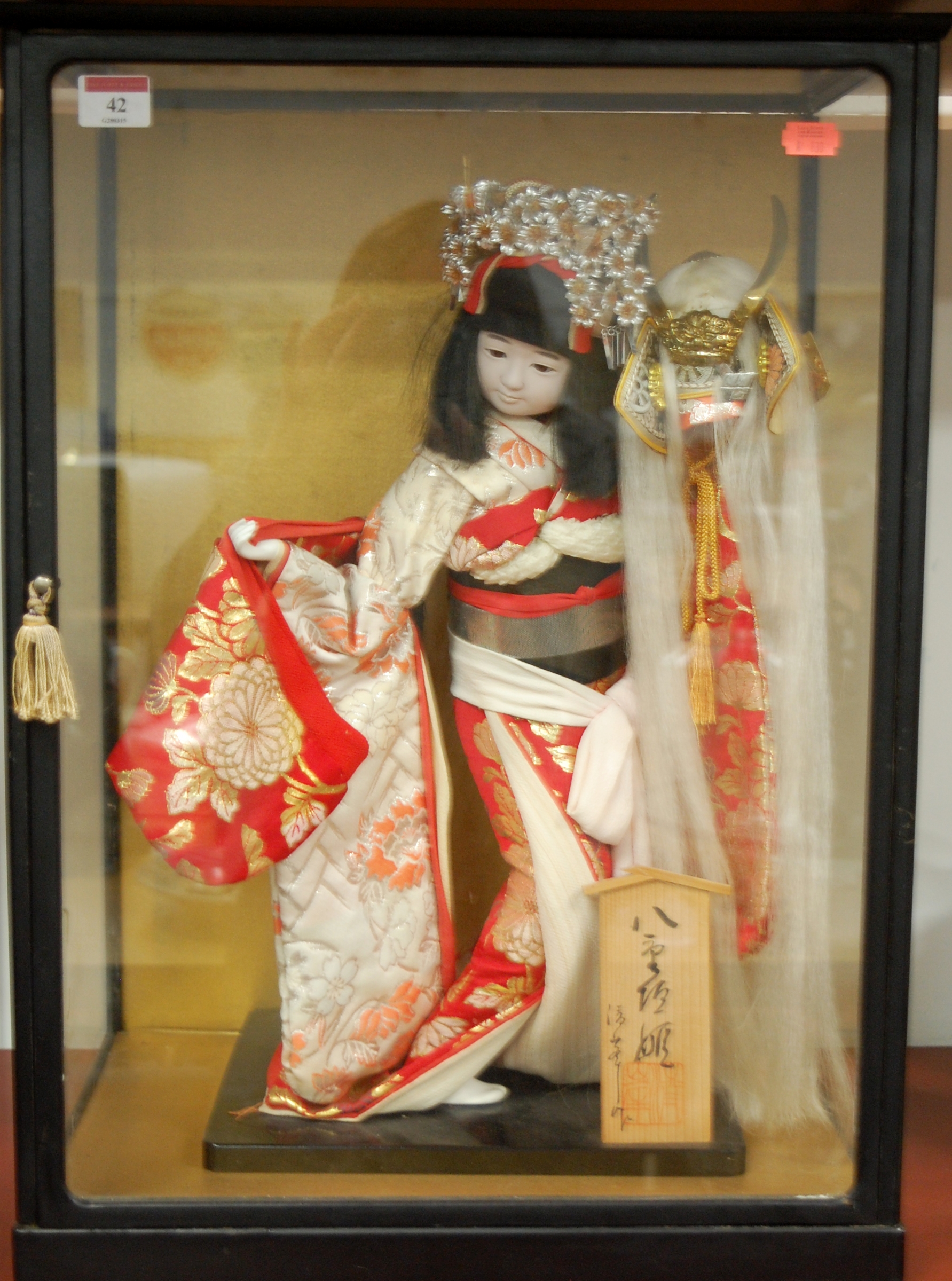 A cased Japanese model of a Geisha