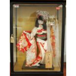 A cased Japanese model of a Geisha