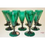 A set of 9 conical shaped green glasses