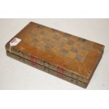 A folding leather bound games board in t