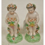 A pair of porcelain cherub groups, after