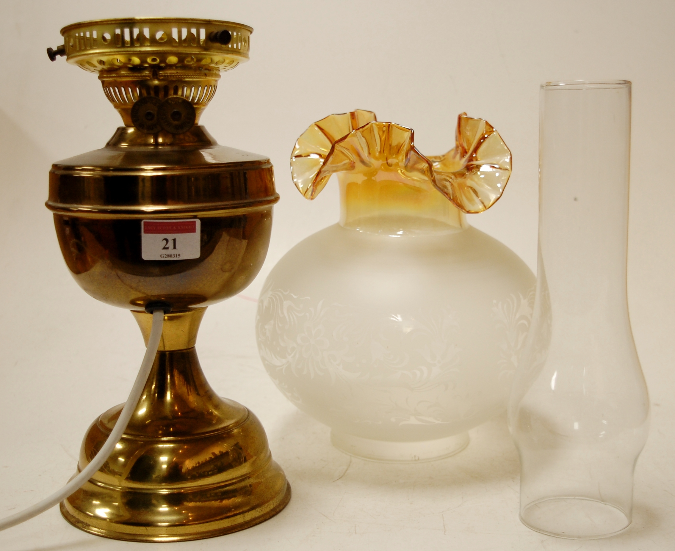 An early 20th century brass oil lamp wit