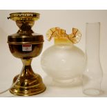 An early 20th century brass oil lamp wit
