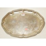 A silver salver of shaped oval form havi