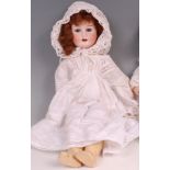 A Heubach Koppelsdorf of Germany bisque headed doll, having rolling eyes, painted features,