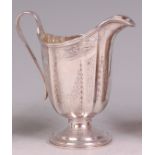 A Victorian silver pedestal cream jug, of helmet form, with bright cut engraved decoration and