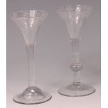 An 18th century pedestal wine glass, having a bell shaped bowl, acid etched with fruiting vines,