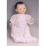 An Armand Marseille Chinese bisque headed doll, having rolling brown eyes, painted features and