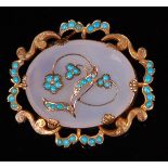 A late Victorian pinchbeck moonstone and turquoise set brooch, having pierced and engraved border,