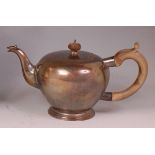 A Victorian style silver teapot, of bullet shape, with walnut handle, raised on footed base, 21.