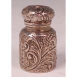 A late Victorian silver scent bottle, of embossed cylindrical form, with hinged cover, maker CM,