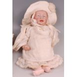 A Kammer & Reinhardt bisque headed baby doll, having painted features, composition body, and wearing