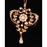 An Edwardian 9ct gold and seed pearl set openwork pendant brooch, on associated finelink neck chain,