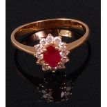 A ladies yellow metal ruby and diamond cluster ring,