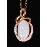 A contemporary 14ct gold opal and diamond set pendant,
