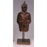 An antique lacquered bronze Far Eastern Buddha fragment, holding a pot and cover,