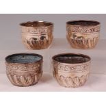 A set of four late Victorian silver table salts, each of half spiral fluted circular form,