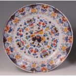 An 18th century Dutch Delft charger, probably from the De Drye Clocken factory, polychrome decorated