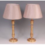A pair of 19th century gilt bronze table candlesticks, later converted into table lamps,