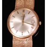 A 1960s gents Omega 9ct gold cased bracelet watch, having a signed silvered dial with baton markers,