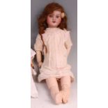 An SFBJ of Paris bisque headed doll, having fixed blue eyes, painted features, composition body with