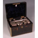 A William IV coromandel fitted travelling toilet box, the brass bound box with fitted double lever