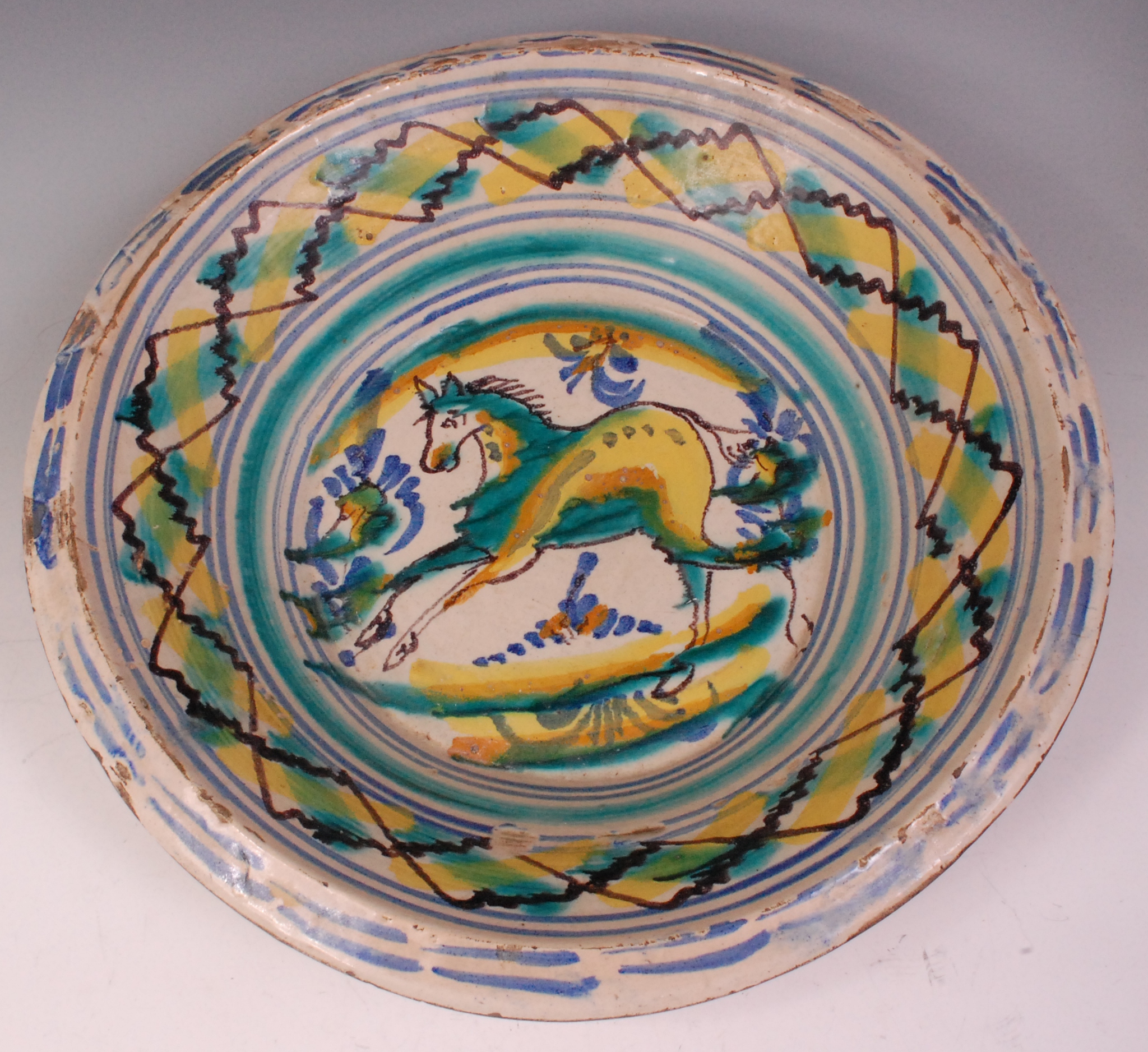 An 18th century heavily potted continental (probably Spanish) maiolica bowl, of good size,